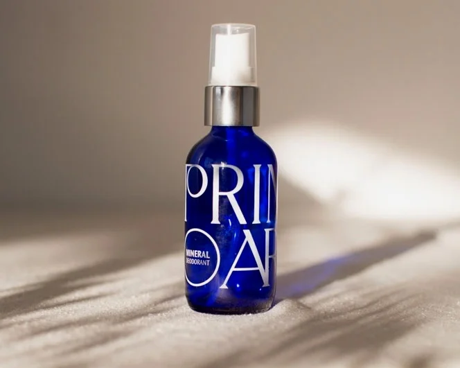 deodorant in cobalt blue glass spray bottle with white ink screen printed logo