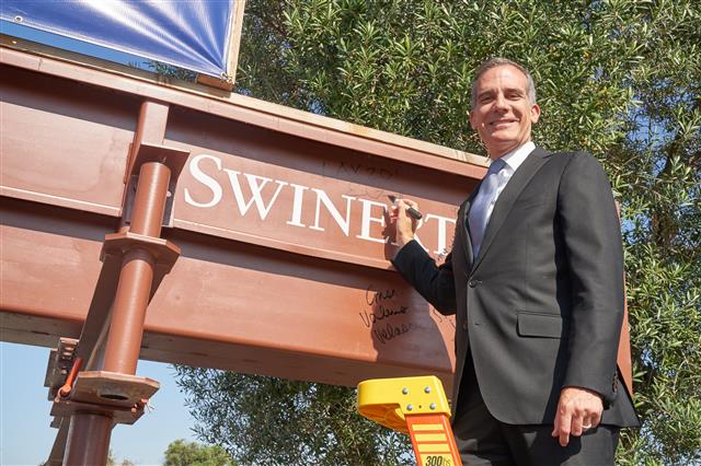 Mayor Eric Garcetti signs a beam at the event, which will be incorporated in the future structure.