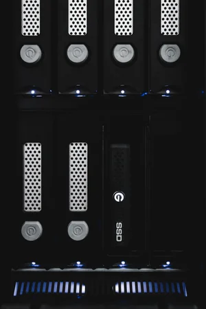 ev Series Bay Adapter with a mounted G-DRIVE SSD, next to the internal drives of the Shuttle XL