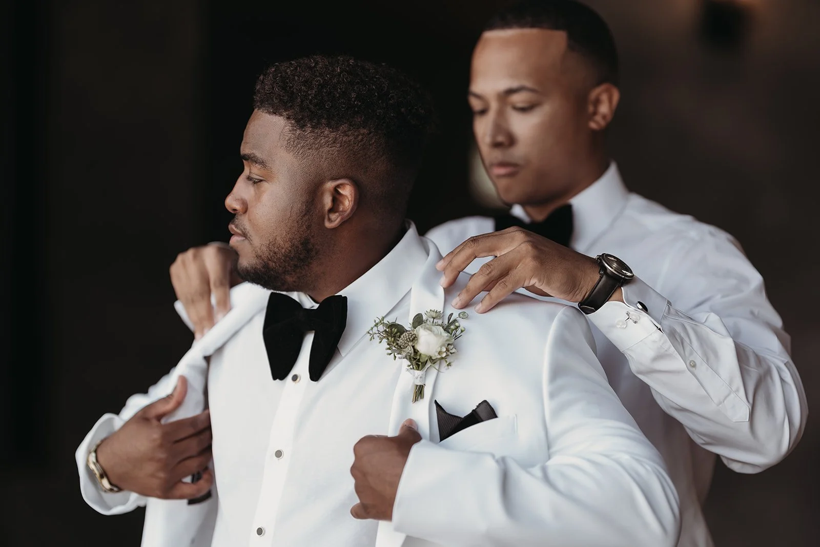 groom in a white dinner jacket