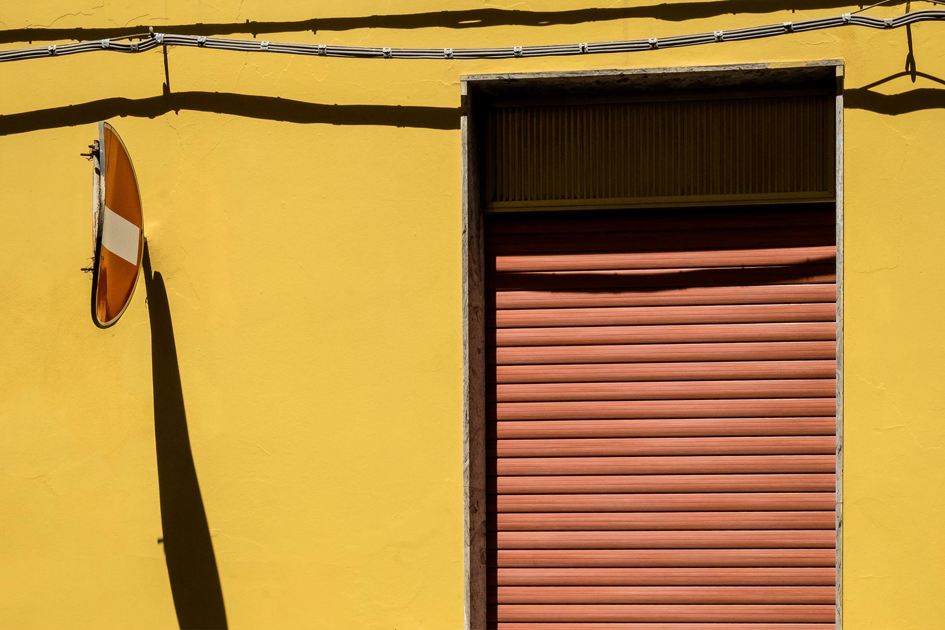 Yellow wall and sign - Floridia, Sicily