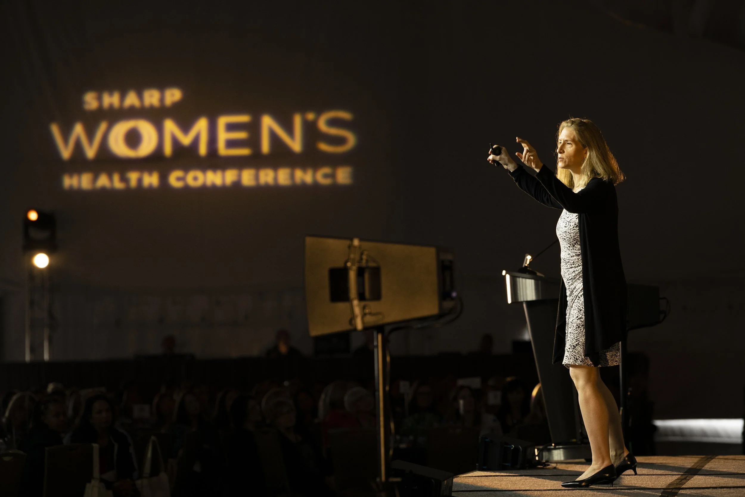 Catherine stands onstage at the SHARP Women's Health Conference