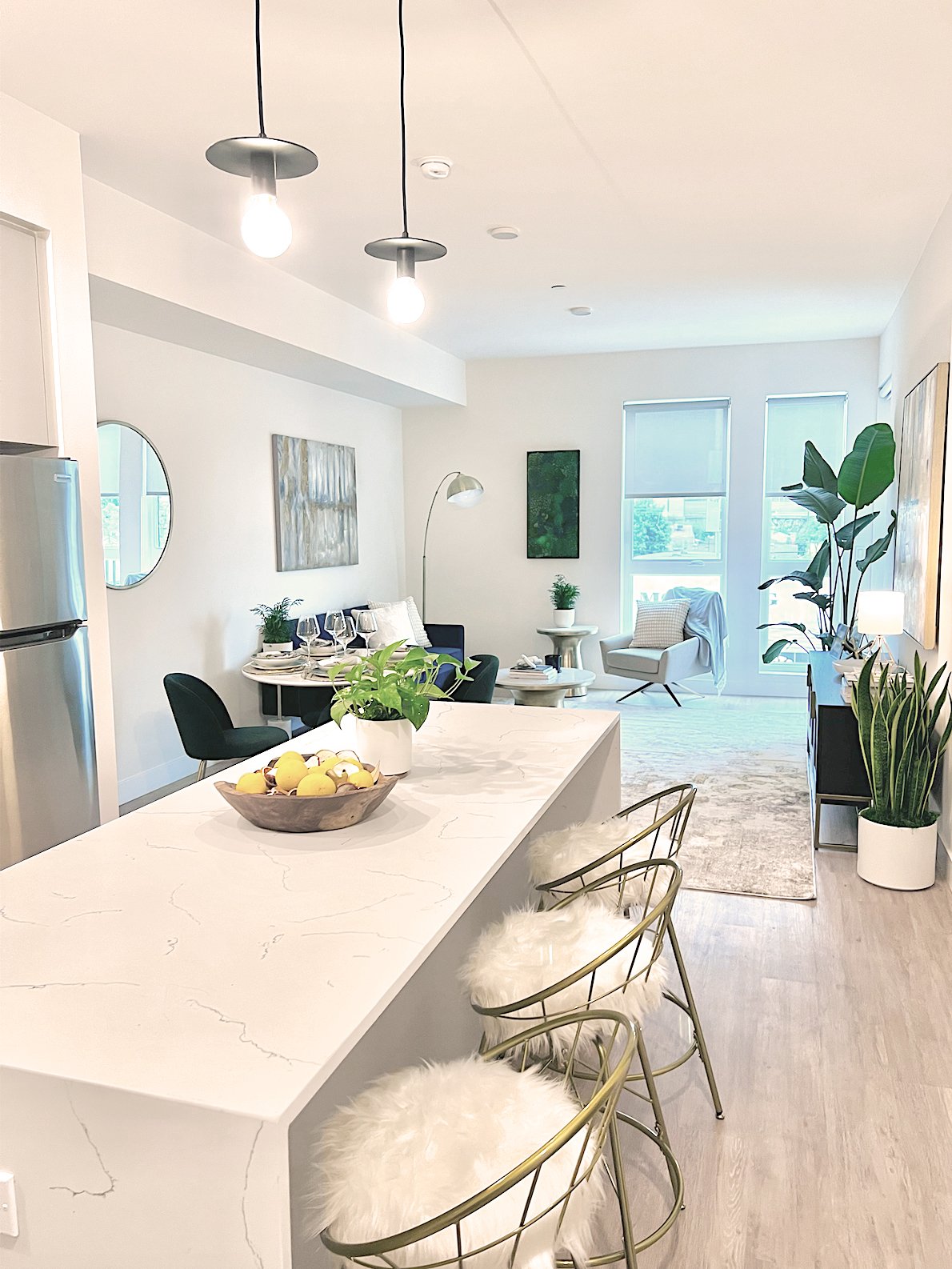 The Rinrose apartments have open-concept living and come with modern, fully equipped custom kitchens with stainless steel appliances, quartz countertops, high-end polished chrome fixtures, and wood LVT flooring throughout.