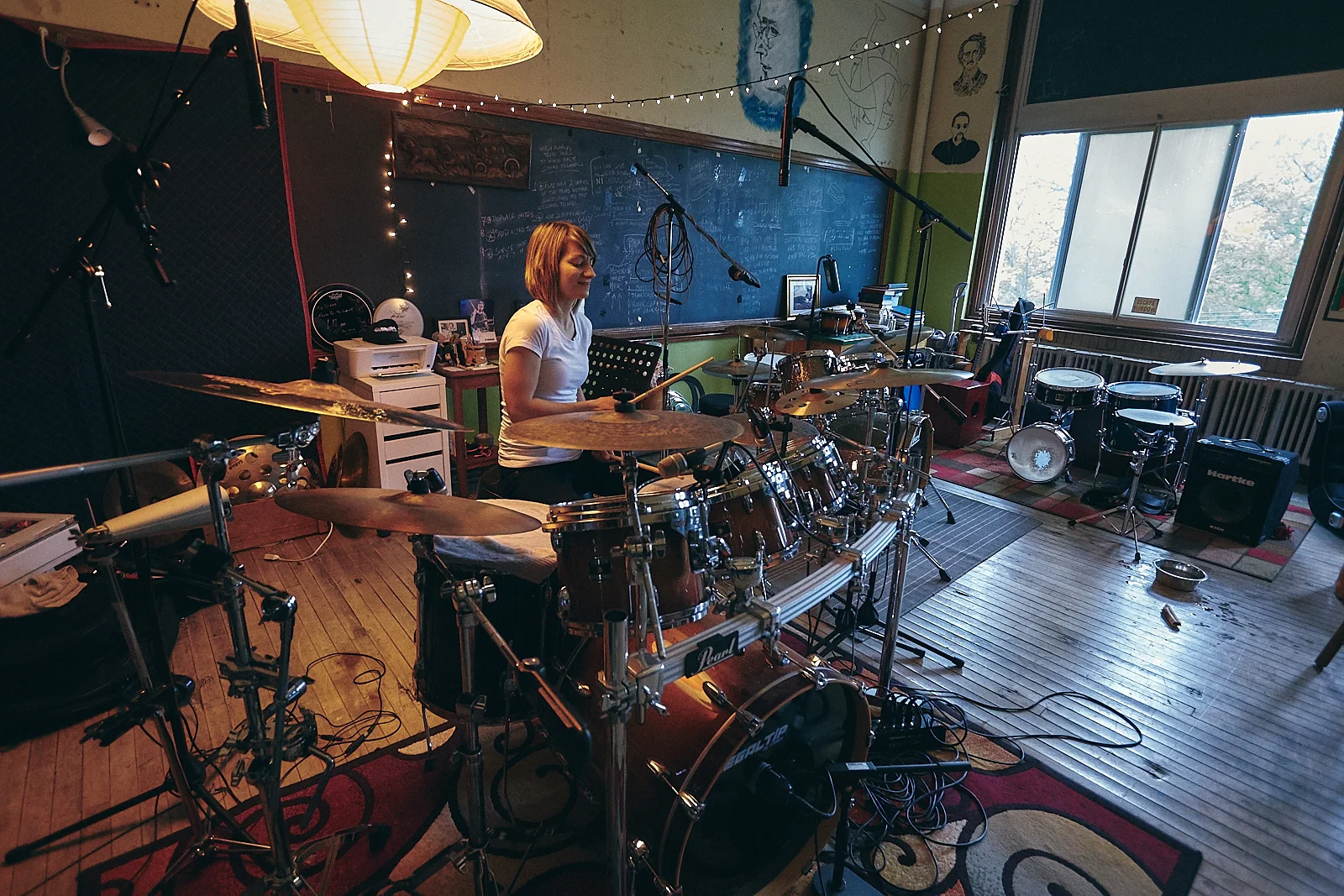 Danisua playing drums at her studio at the Niagara Arts and Cultural Center