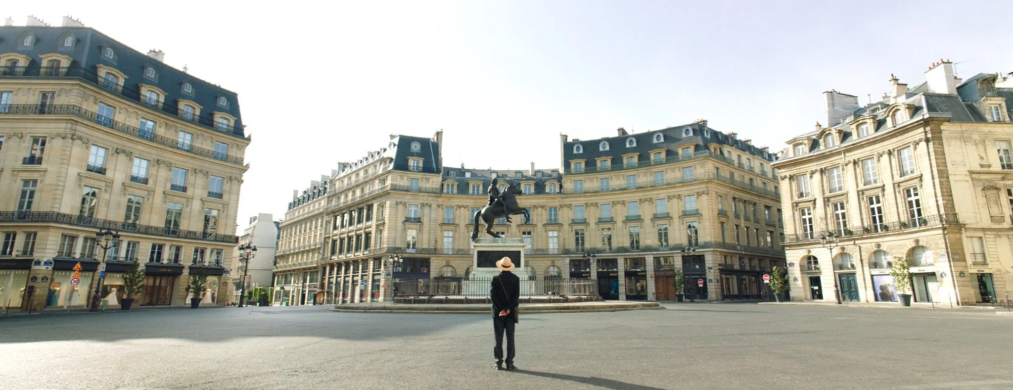 man-looking-at-statue-in-Parisian-square.jpeg