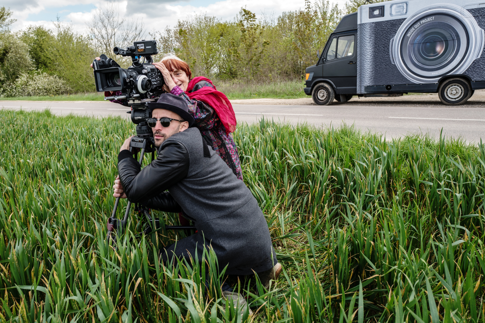 man-and-woman-standing-beside-road-with-camera.webp
