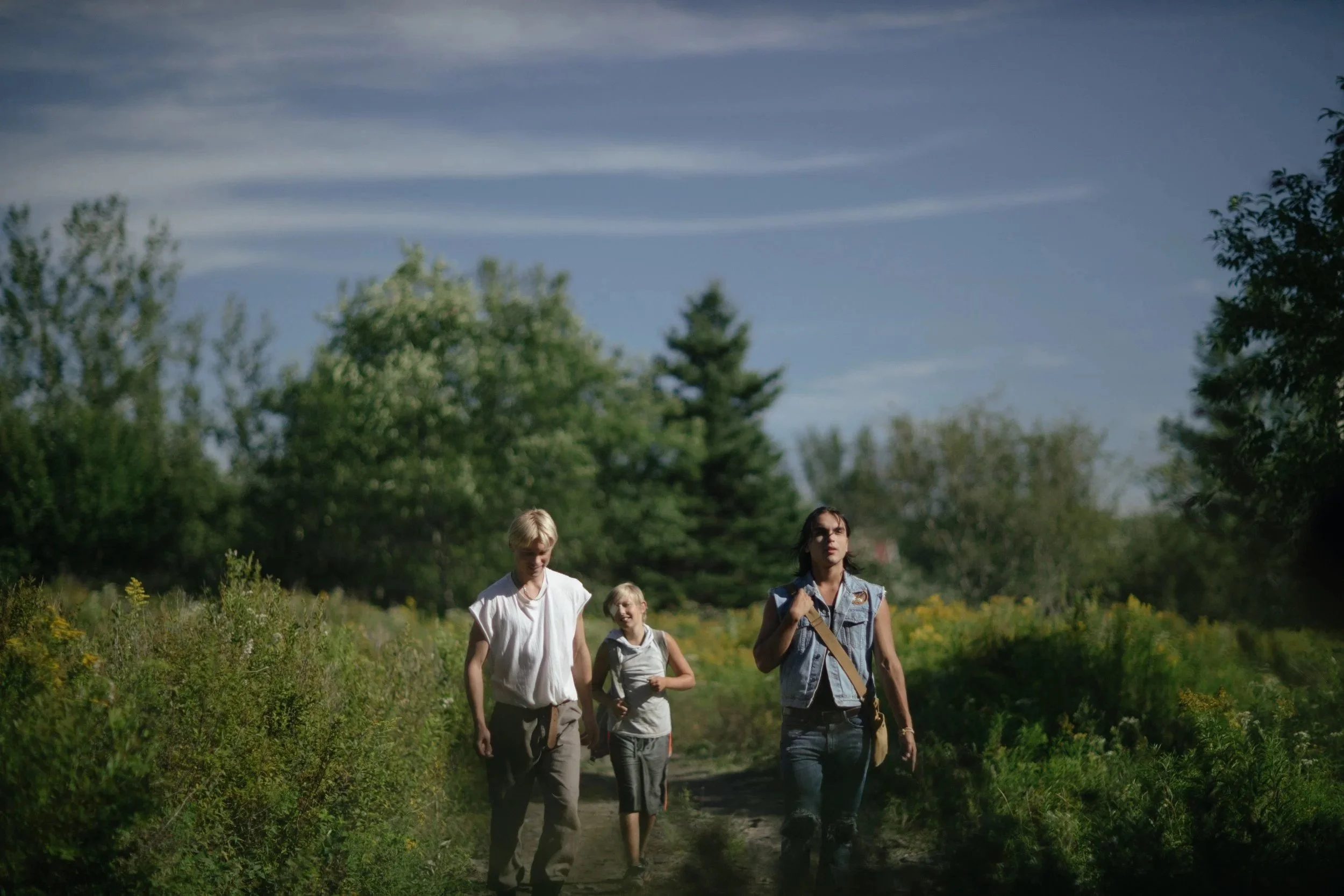 three-young-people-walking-through-forest.jpeg