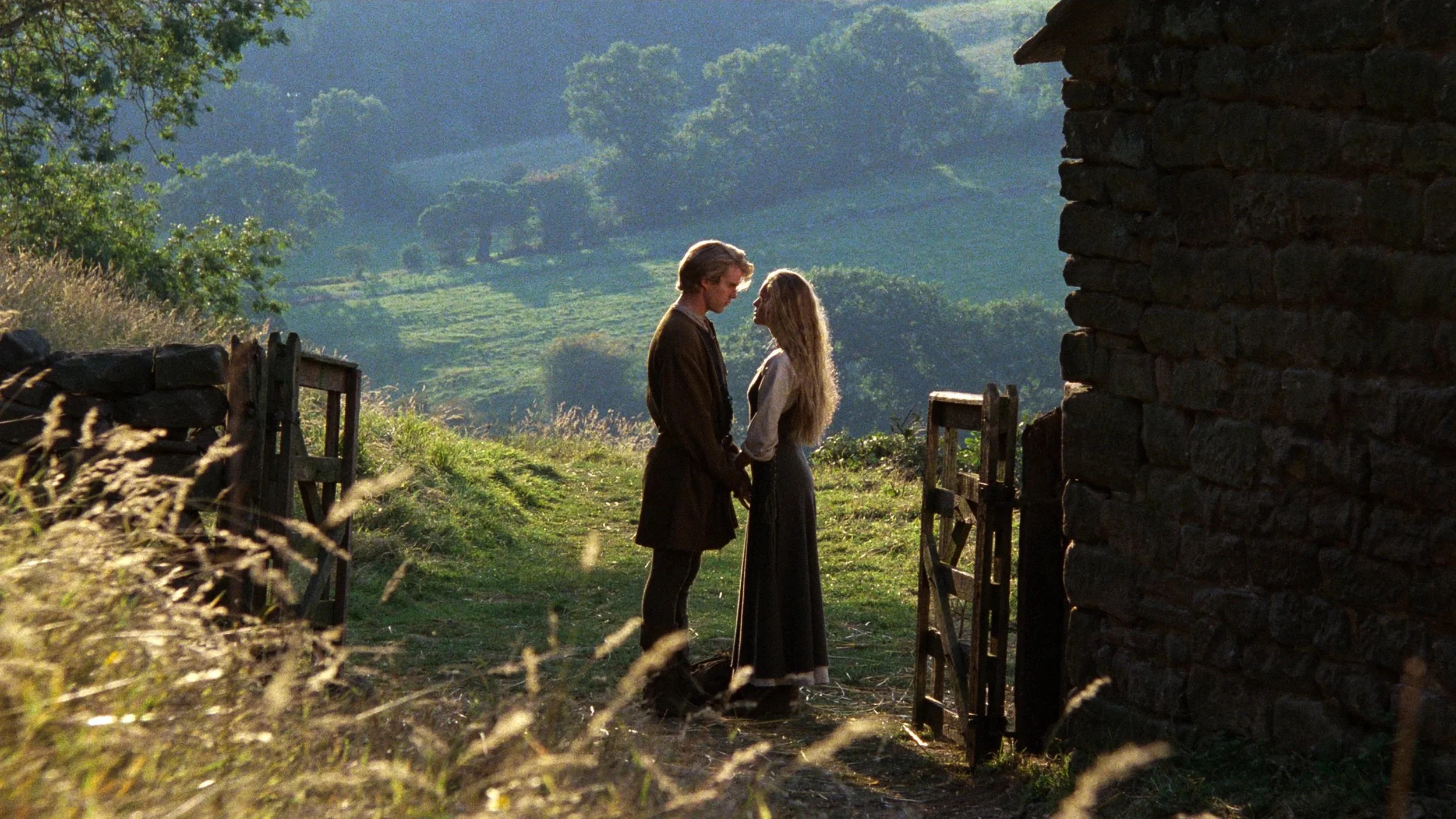 man-and-woman-hold-hands-near-farmhouse.jpeg