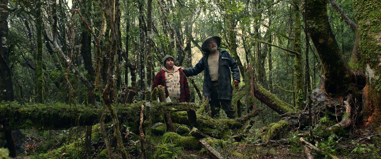 a-man-and-a-boy-standing-in-a-forest.jpg