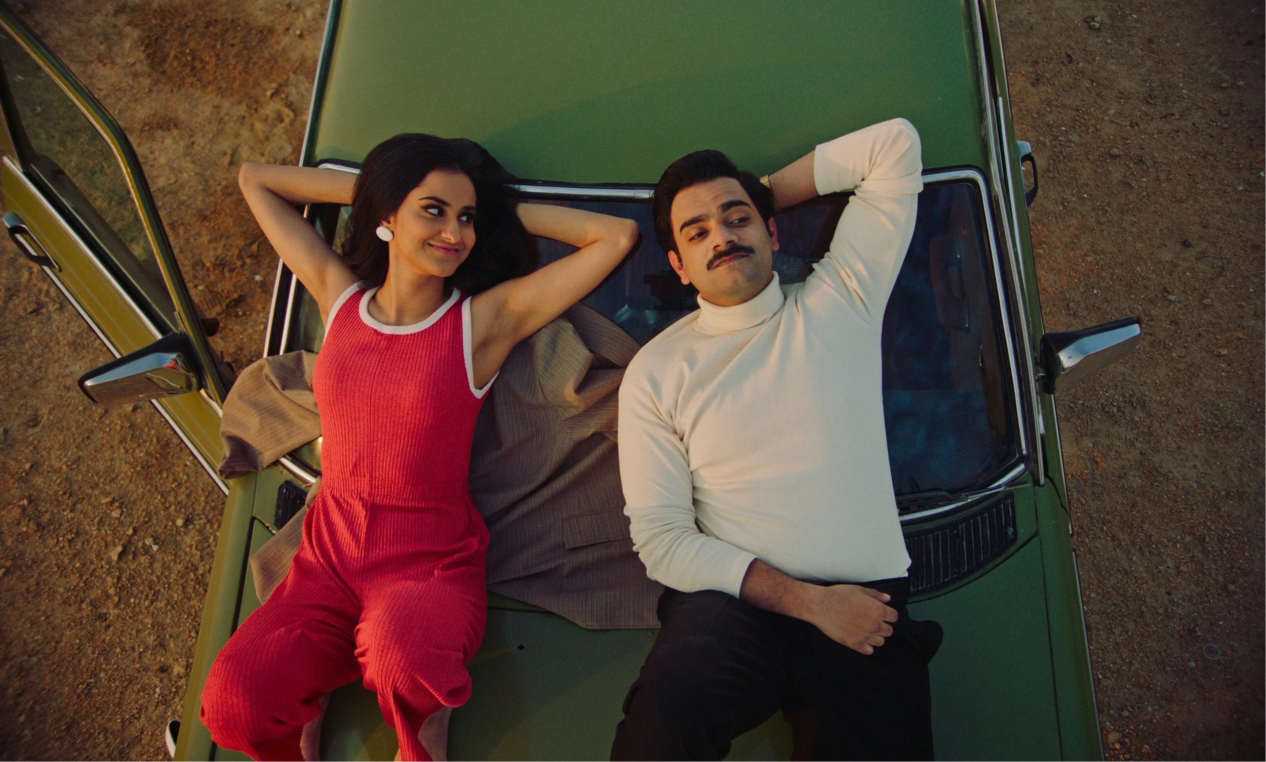 man-and-woman-lying-on-car.jpeg