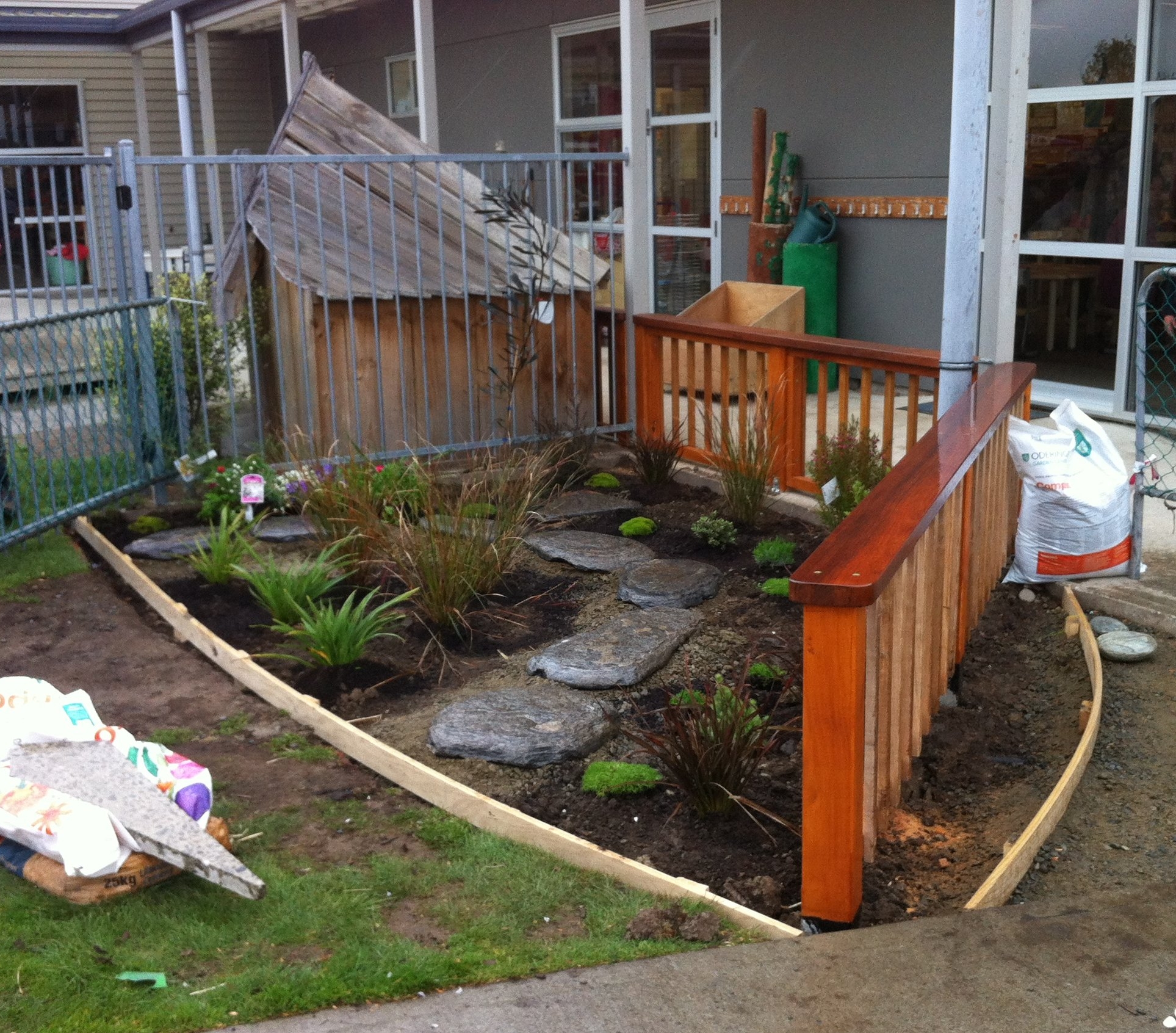 NatureFlow built a small fence to act as a boundary - channelling people coming out of the centre onto the pathway. We added a small paver pathway, putting plants on either side which will grow up to create a tunnel effect for young children. 