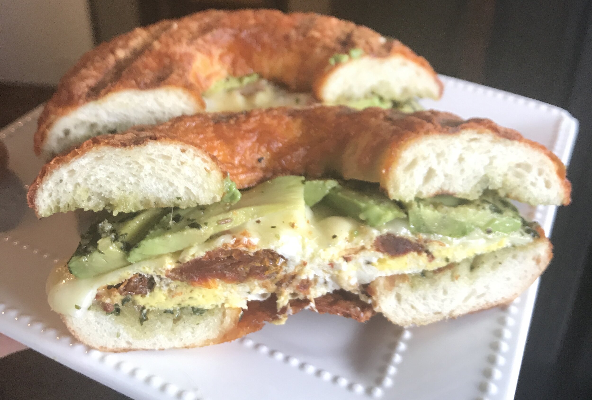 Rozz with avocado on cheddar bagel