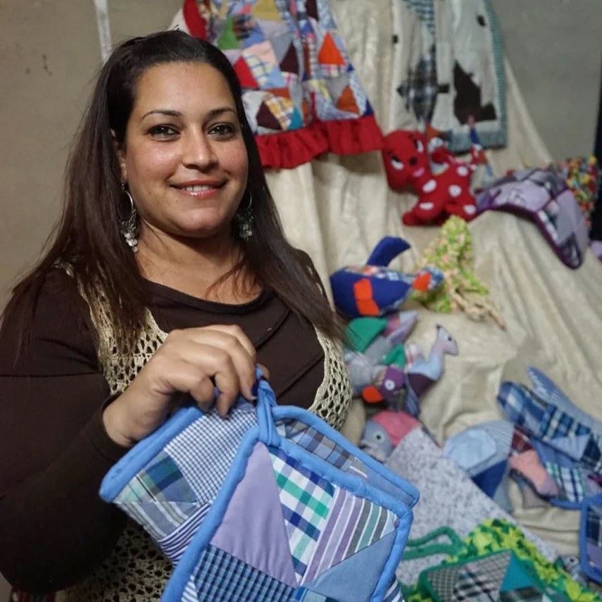 A seamstress sells beautiful goods.