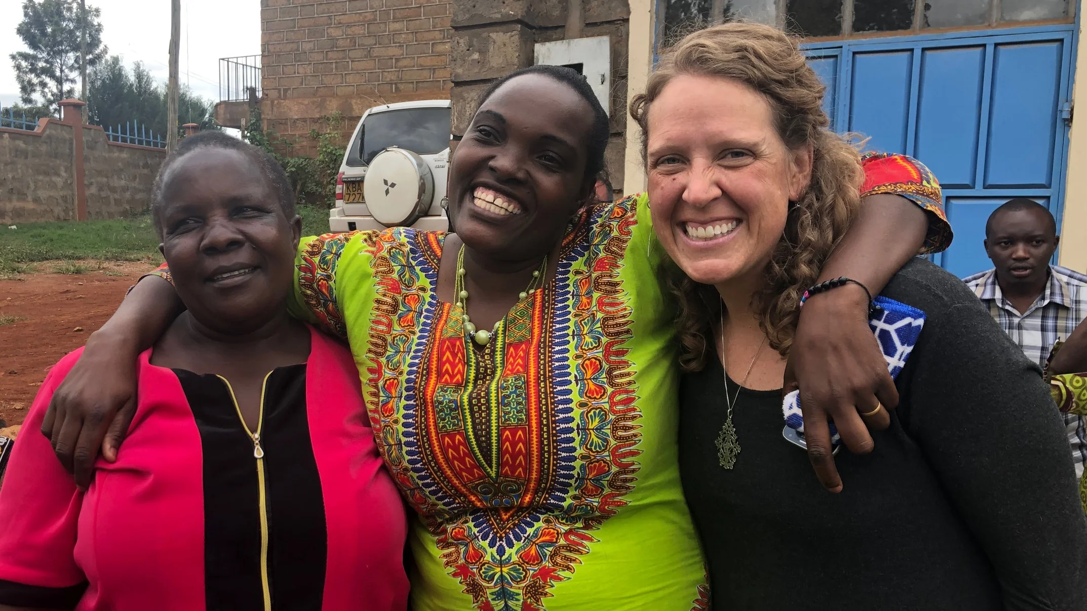 Erin (right) with client Rose (center), who's building a dressmaking business with a $300 TOLI loan.