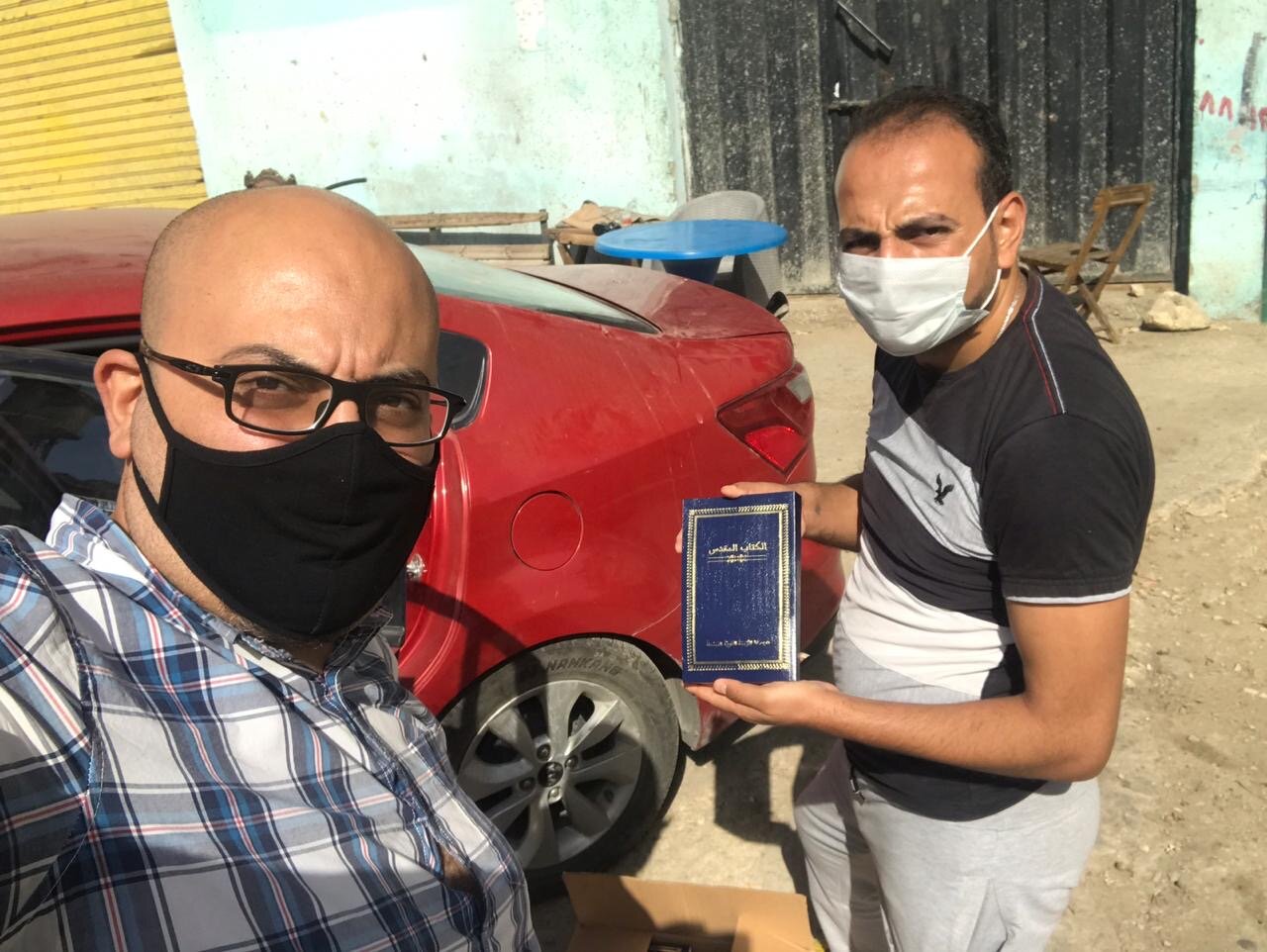 Saeed and Maged with Arabic bible to be delivered.JPG