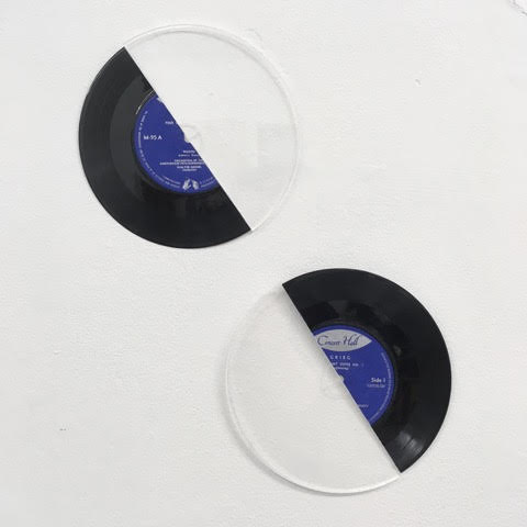 16 2/3 (2019). Vinyl, acrylic. 17.78 cm. Wall-based work presenting two halves of a 7” vinyl disc and a cake decorating plate combined together to form a work that repurposes the music record as a sculptural object with minimalistic sensibilities, underscored by the choice of synthetic material and arrangement of the assemblages.