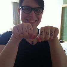 Valerie posing with "Lil Bub" written on her knuckles.