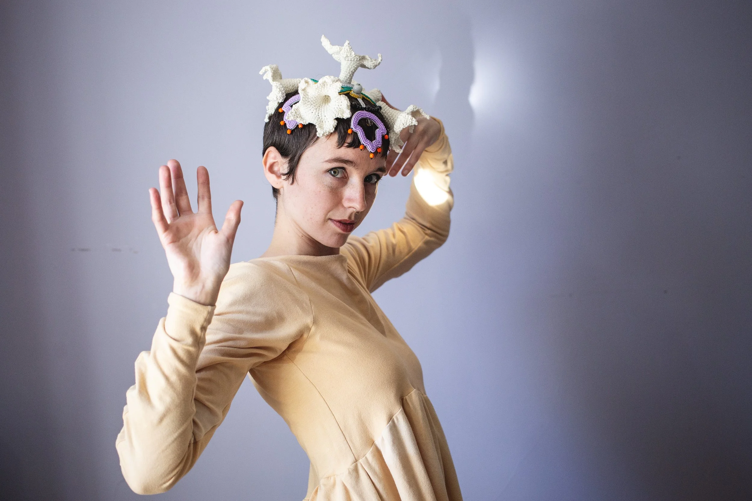 Artist Callen Maude wearing a crochet and beadwork flower headpiece