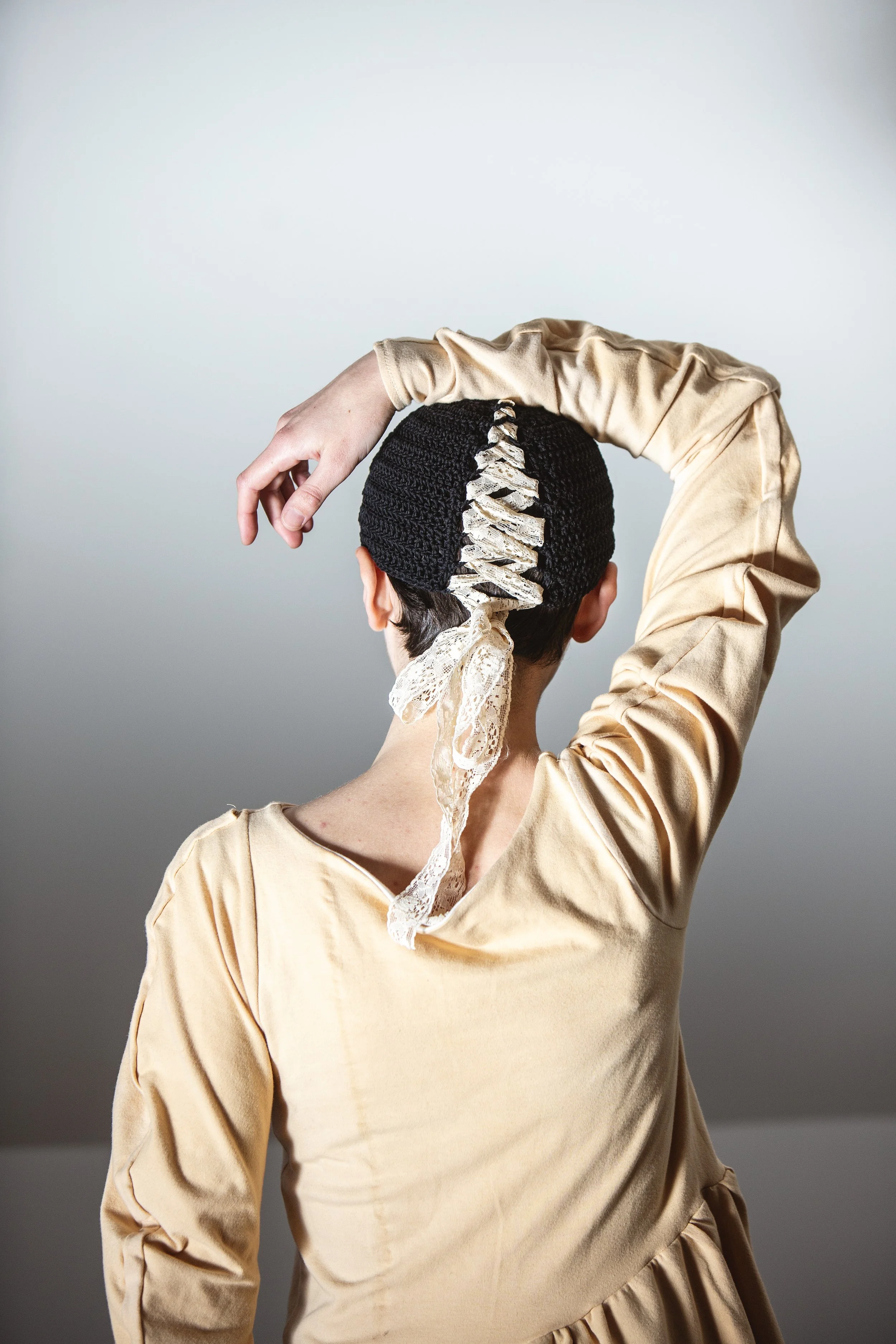 Artist Callen Maude wearing one of a kind crochet Belladonna mask