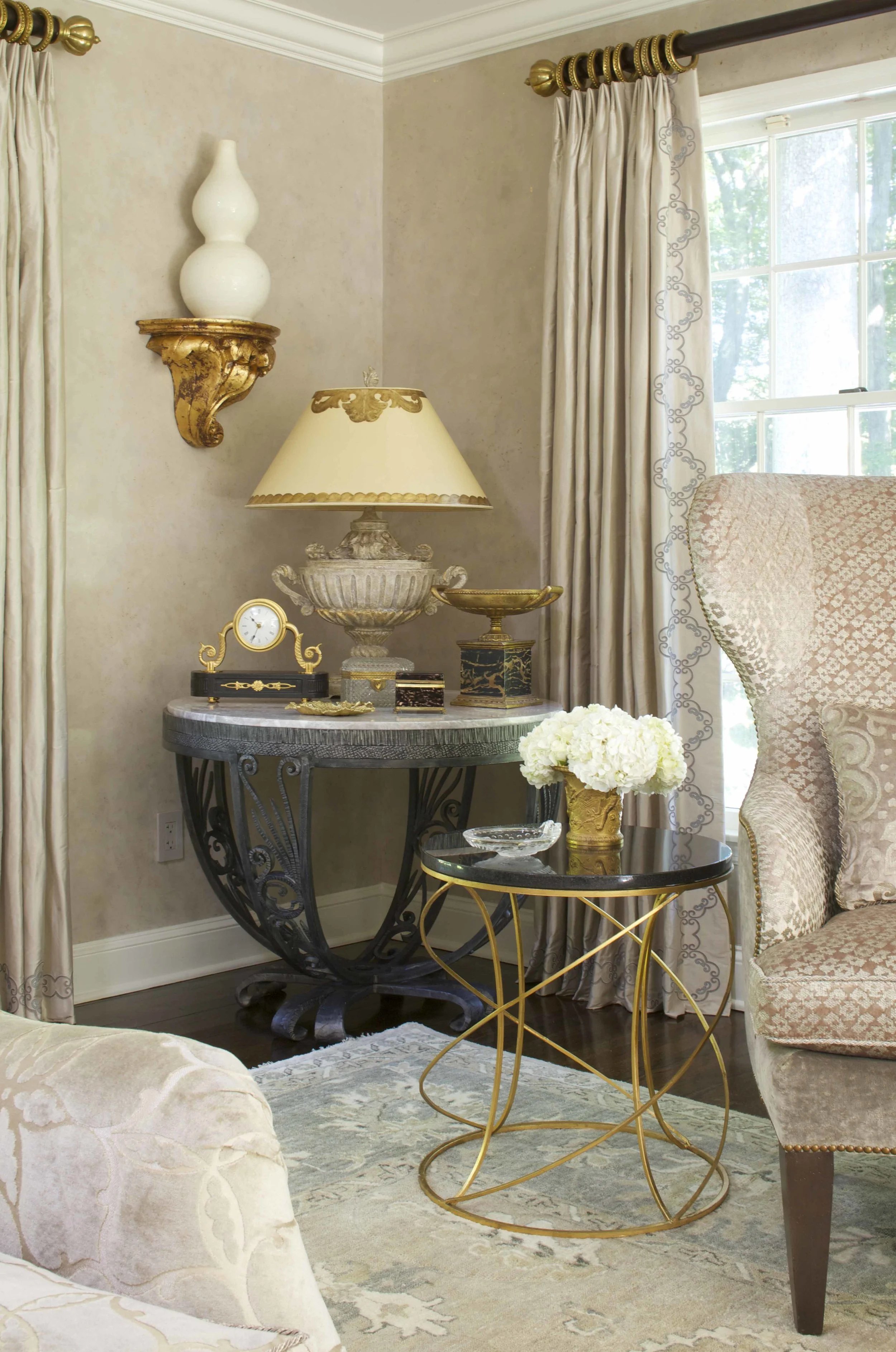Enbroidered silk curtains and Venetian plaster walls flecked with gold leaf