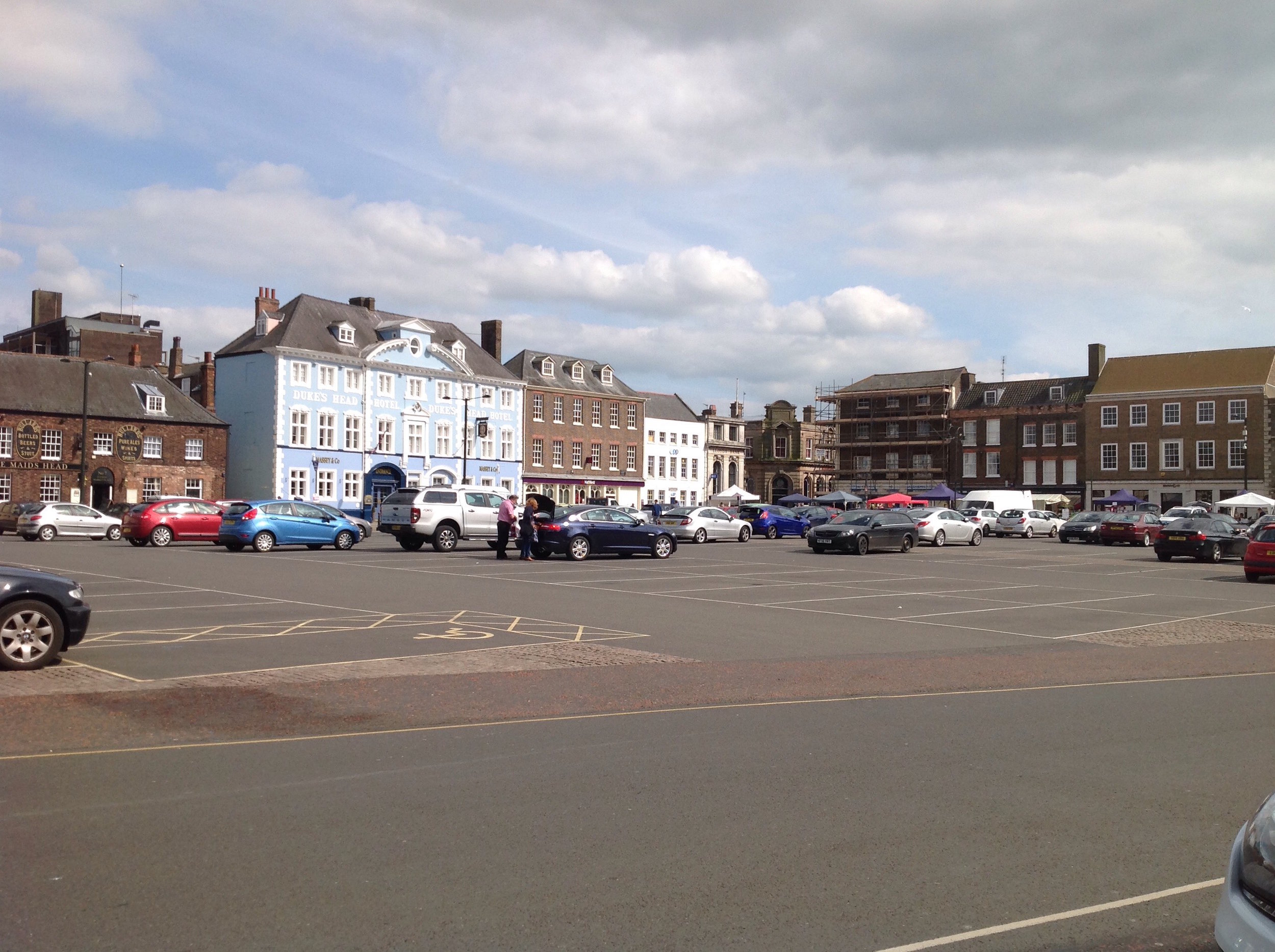 Tuesday Market Place looking towards the Duke's Head hotel. This area is now largely car park, with a few market stalls every Tuesday at the south end nearest to the high street.