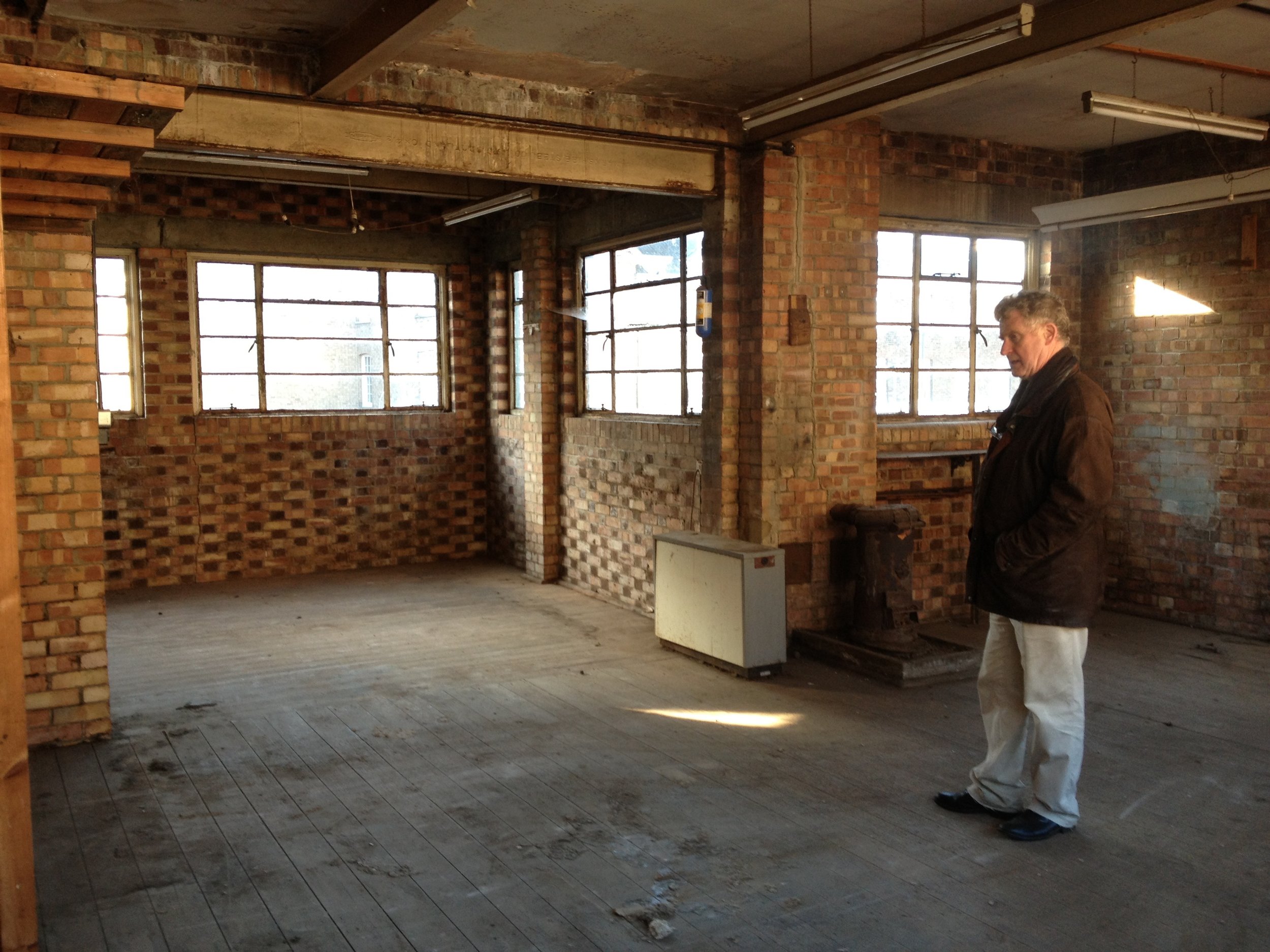 Sandy Heslop contemplating the empty upper floor before construction began.