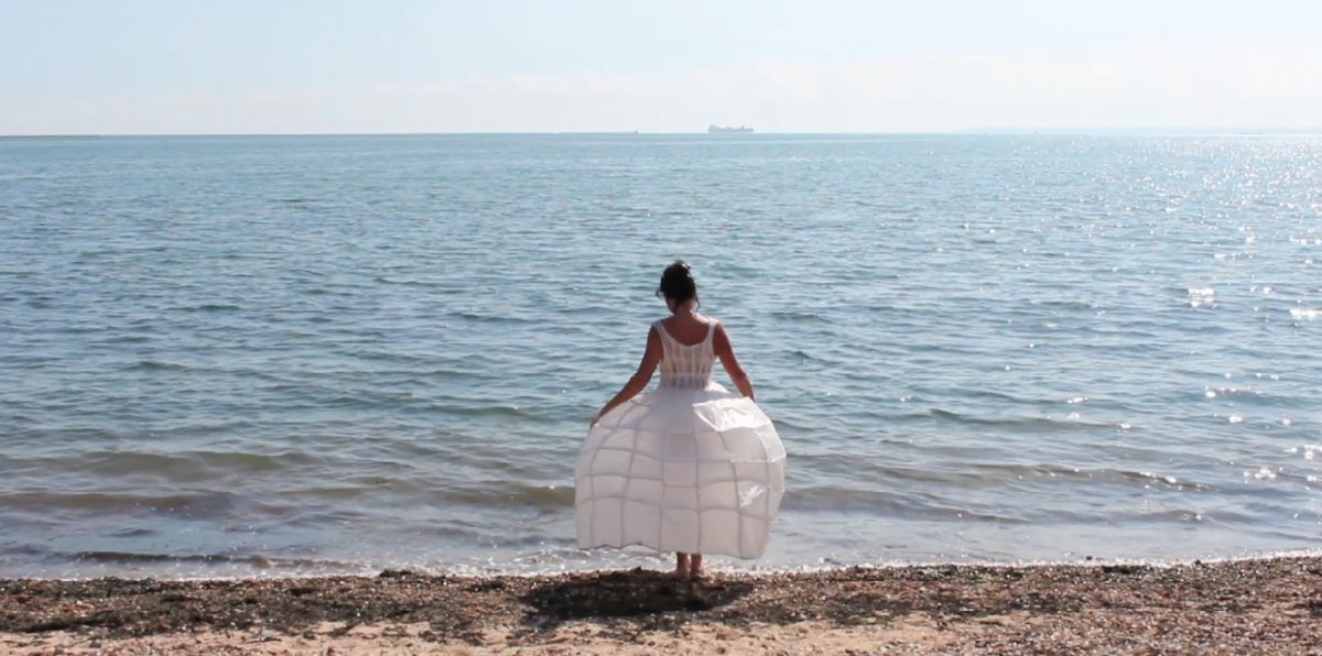 Dress, sea; a video installation by Lynn Dennison. The artist performs this mysterious ritual, walking slowly into shallow waters of the sea, until she is submerged. The work makes an interesting parallel to Simon Faithfull’s ‘Going Nowhere 1.5’ and in the gallery they are seen opposite each other.