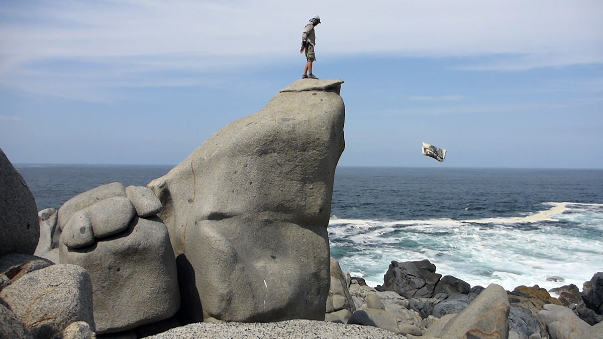 Peter Matthews on a recent drawing trip to Chile. The artist makes durational drawings while he is submerged in the ocean and paintings using the elements, the sea and local pigments and stones. Here he is throwing a canvas into the water.