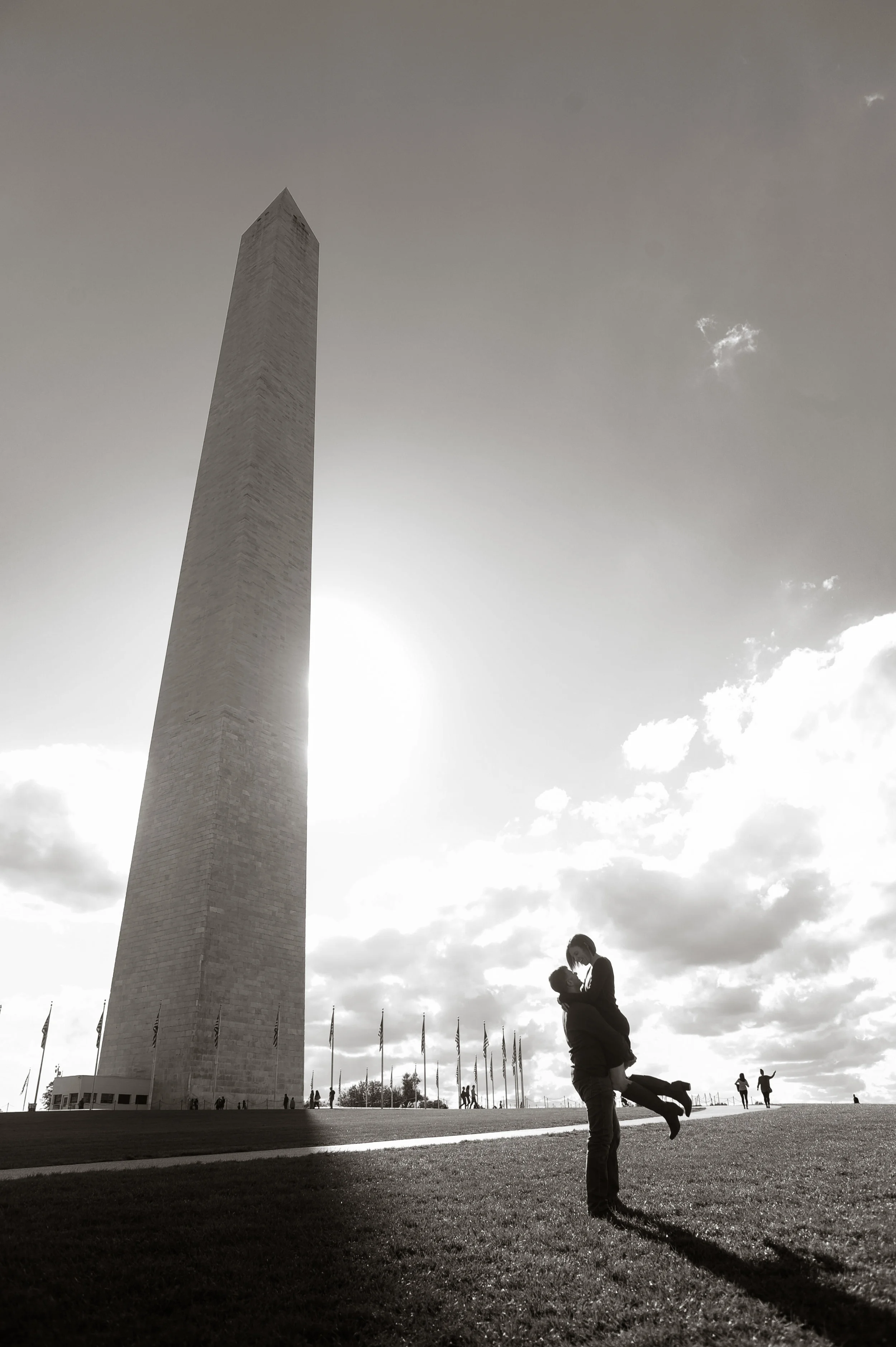 Couple silhouetted next to the Washington Monument