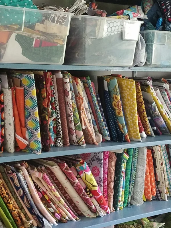 Bolting up your fabric is easy. Fold it lengthwise twice, so that it's about 10 or 11 inches wide. Neatly wrap it around the comic book cardboard, then slip it on a shelf, stand it on edge in a drawer, or stack the mini bolts on a cupboard shelf. Fabric bolted this way makes you feel like you have your own little fabric store.