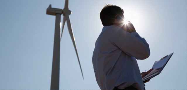 Man%20on%20phone%20in%20front%20of%20wind%20turbine_hmpg_web_jpg.jpg