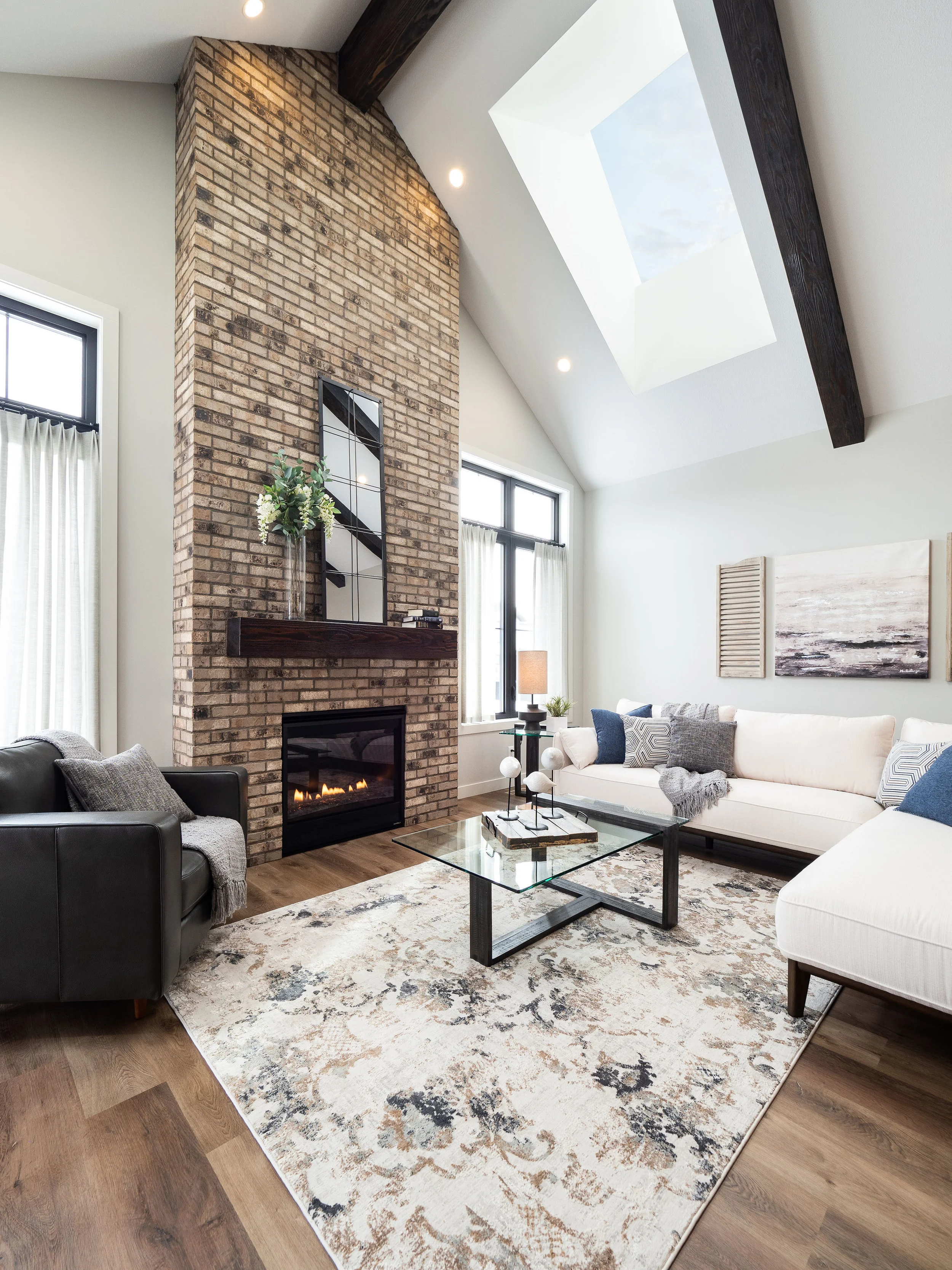 Staring back at you is a floor to ceiling fireplace that seamlessly blends into the vault above. The natural color of brick was the perfect match for the exposed beams which paired with the mantle perfectly.