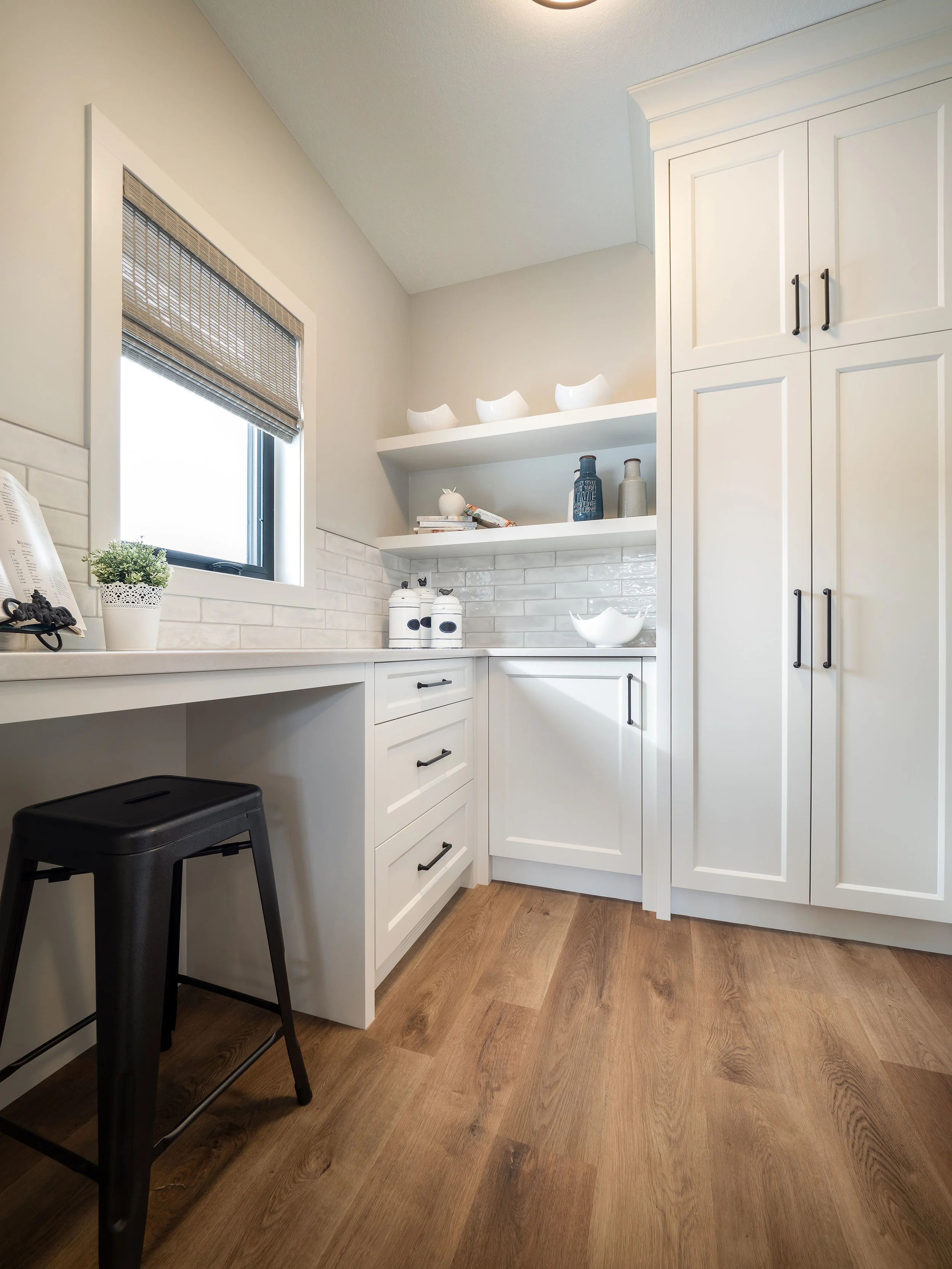 A walk through butlers pantry off the garage is the ideal location to unload those groceries and also function as a drop station.