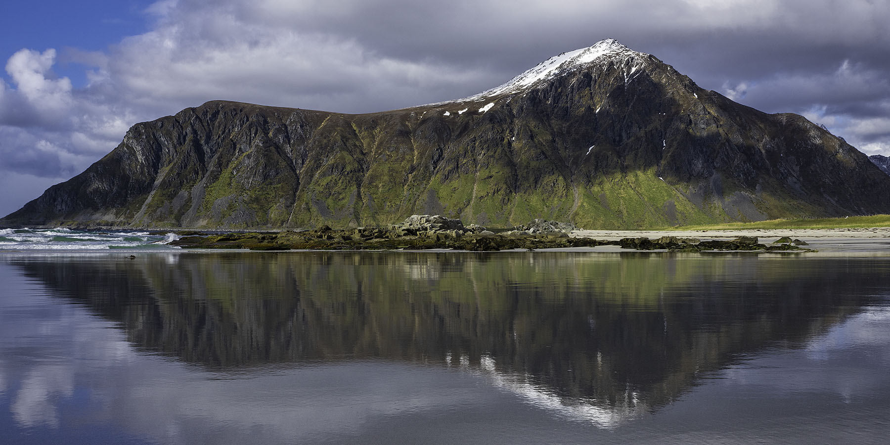 Mount Hustinden's reflection on the wet sand of Skagsanden beach - Flakstad, Lofoten Islands, Norway