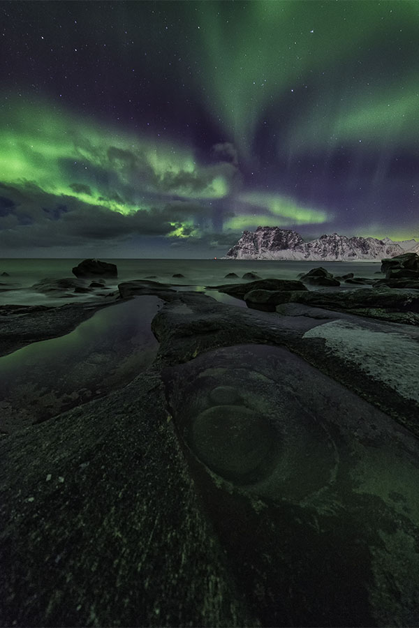 Northern Lights over the Dragon's Eye of Uttakleiv - Lofoten Islands, Norway