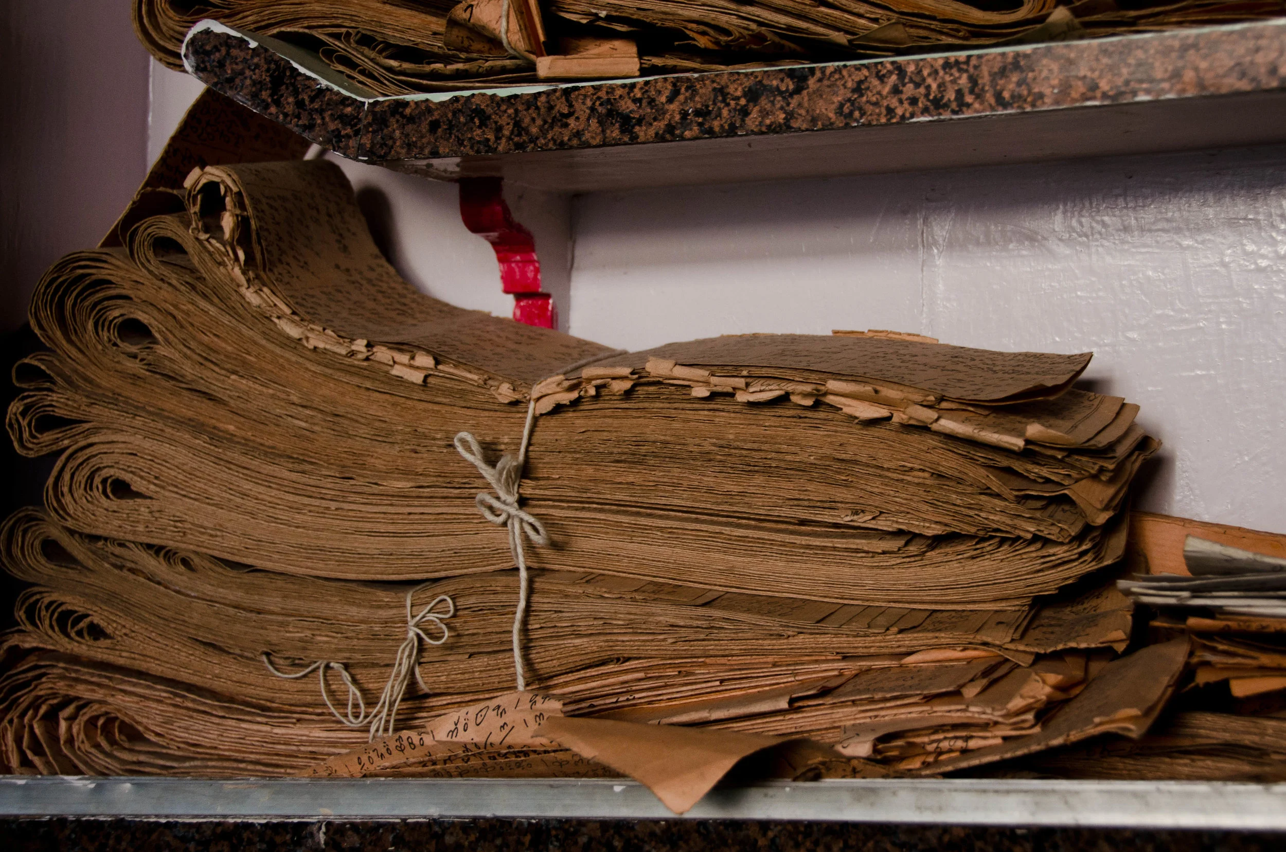 A book of talim. Each page from the talim encodes about 20 rows of the carpet, specifying which colored knots go where.