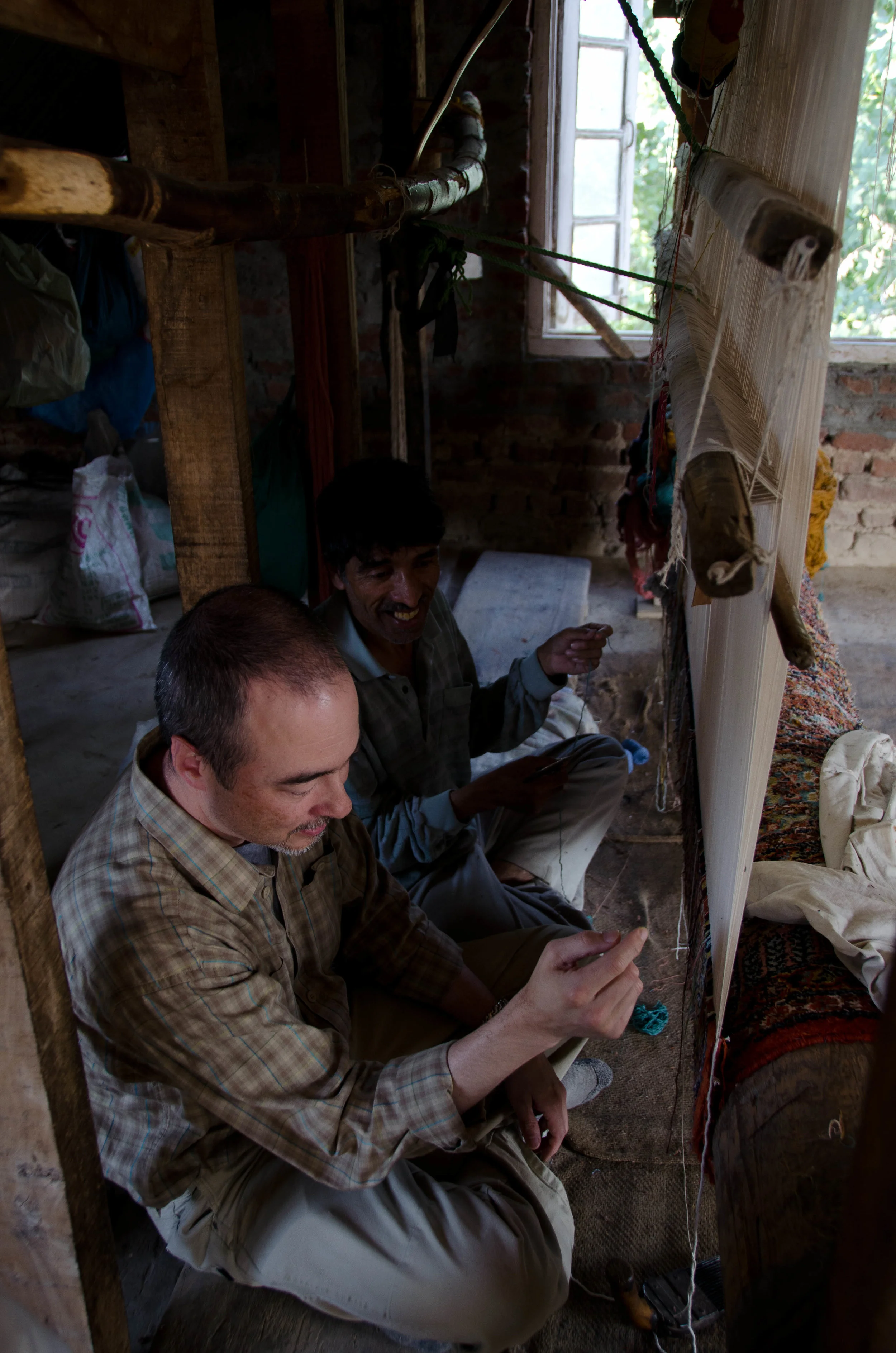 Peter tries his hand at tying carpet knots. It took him a full minute to tie one knot. At that rate, one of his kids would probably have to finish this carpet after he died.