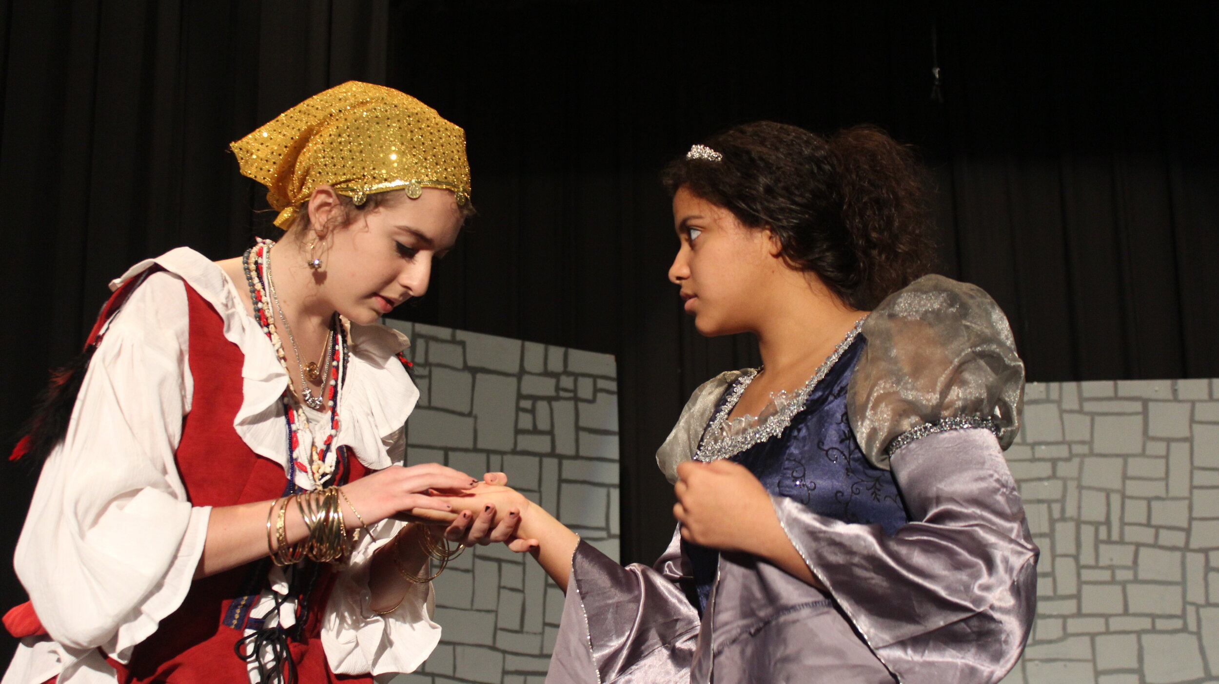  Zhura (Abigail Hilburn) tempts Snapdragon (Alexandra Brown) with her potential destiny in the 2014 production. 