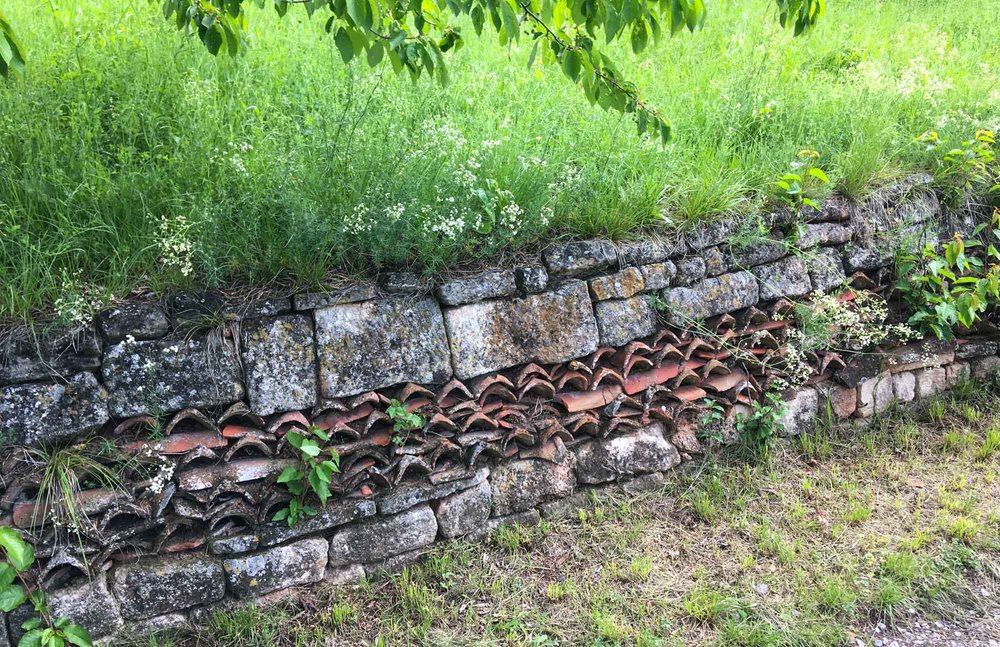 The original stone terraces are maintained to prevent erosion.