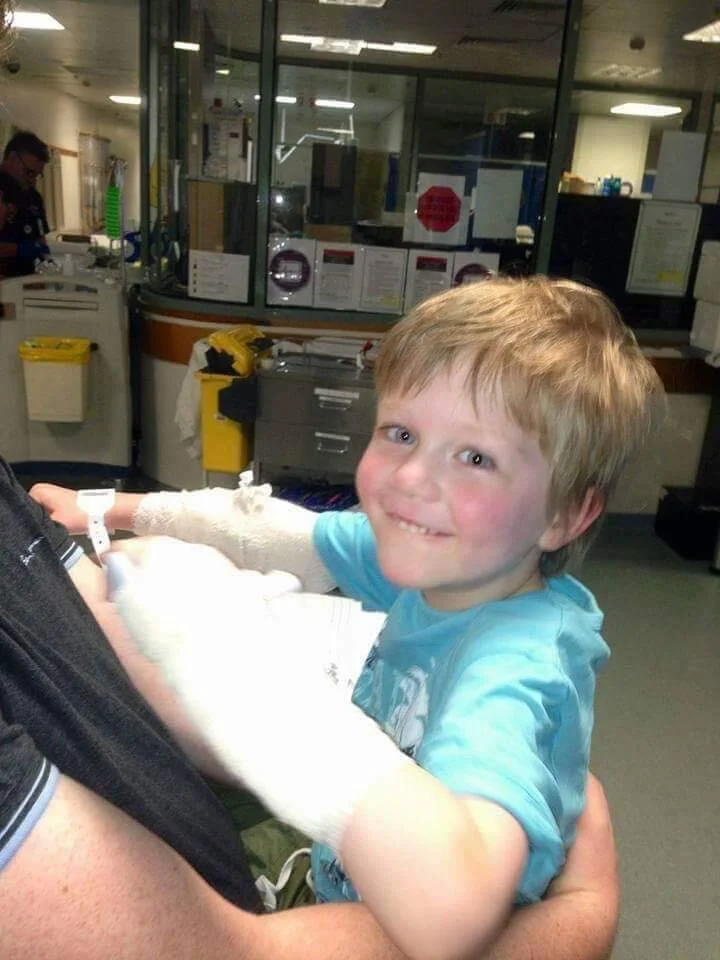 in daddy’s arms, smiling again..