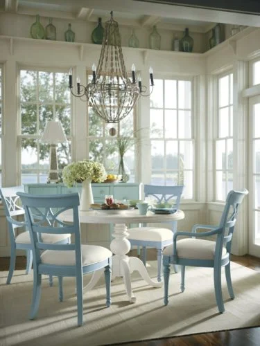 A simple round table, easily available, painted white with fresh morning blue chairs. Source: Pinterest