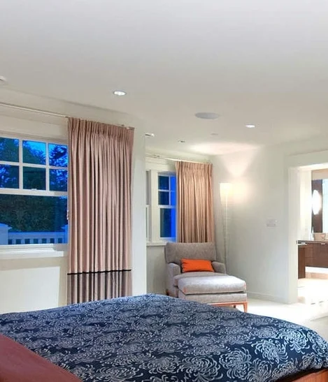 Design: Sophistique Interior Design. Foscarini’s Mite is shown near the lounge chair in the corner.