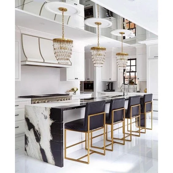 Note the ceiling treatment above the island. The length of the island is reflected in the mirror length on the ceiling. Medallions are attached to form the backdrop for the pendants. A glamorous kitchen for sure. In my view these medallions are not needed. The crystal pendants would reflect amazingly in the mirror without the them. The medallions are confusing to my eye. Source: Pinterest.
