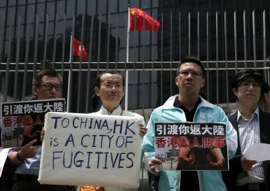 Protesters raise placards against Hong Kong's extradition law at the Legislative Council Hong Kong, April 3, 2019. Image Credit: AP Photo/Vincent Yu