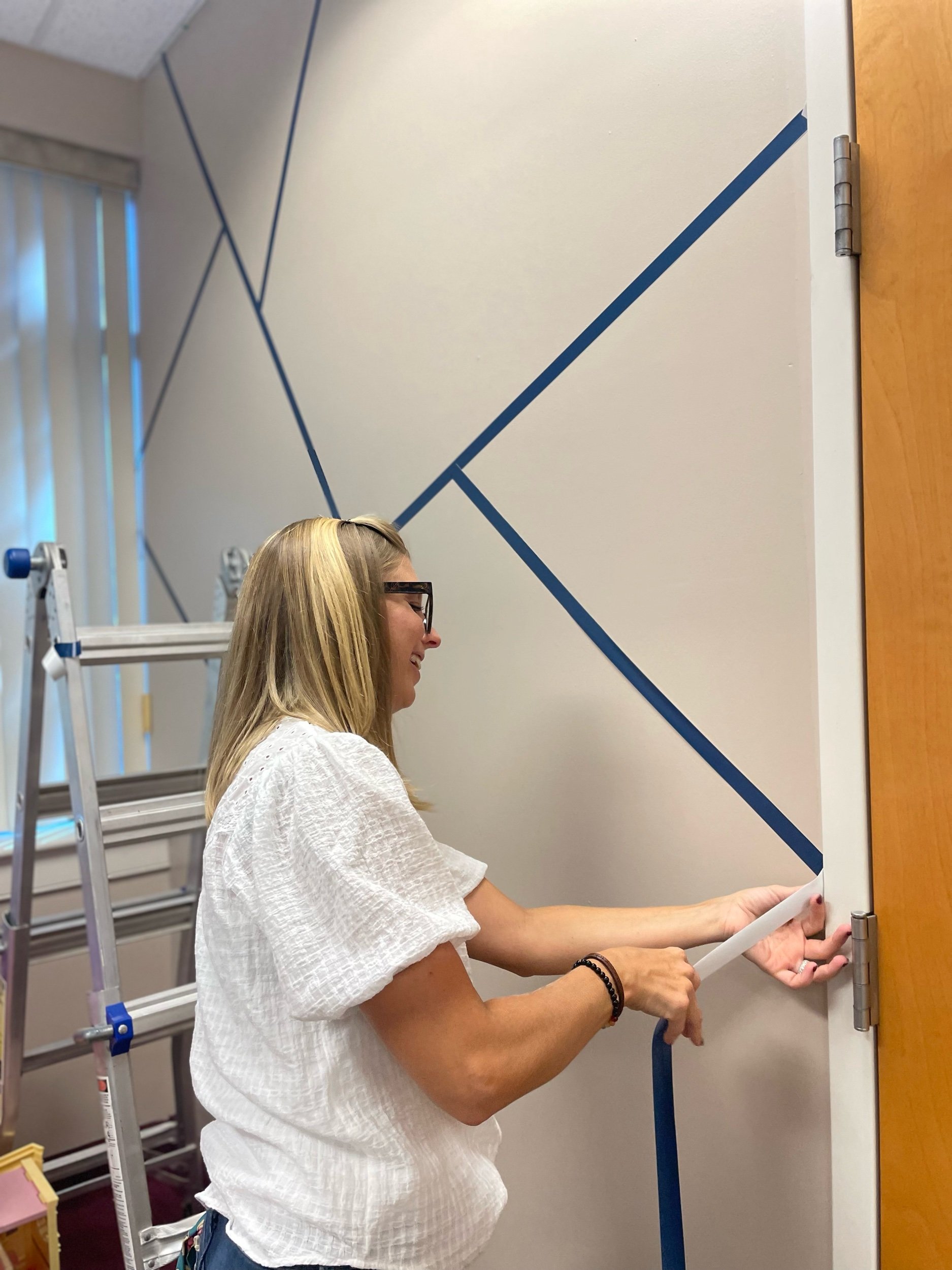  Volunteer installing a wall design. 