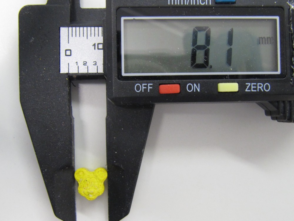 Yellow mickey mouse tablet in calipers (small).jpg