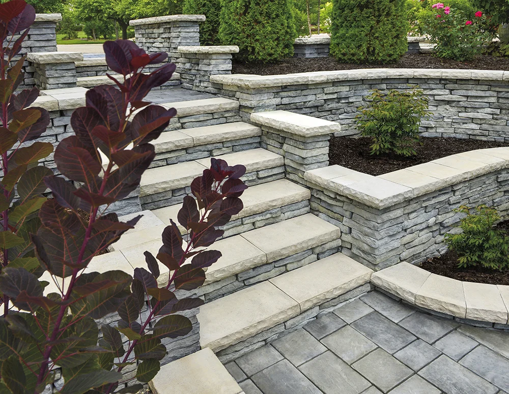 RICHCLIFF PAVER IN DAWN MIST AND RIVERCREST WALL IN COASTAL SLATE WITH LEDGESTONE COPING IN BUFF