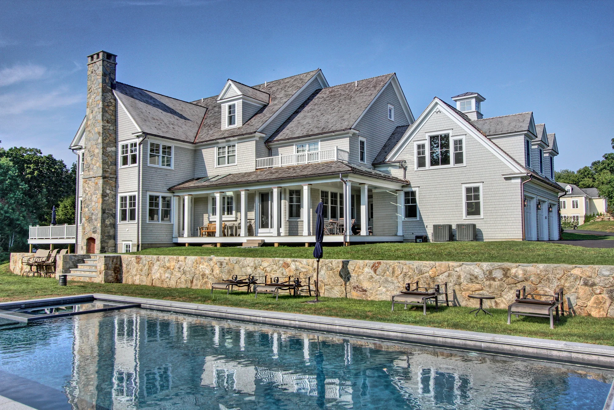 MATERIALS USED: BLUE THERMAL BLUESTONE POOL SURROUND; CT FIELDSTONE, MOSAIC CUT WALLS AND FIREPLACE PHOTO CREDIT: TALLMAN SEGERSON BUILDE