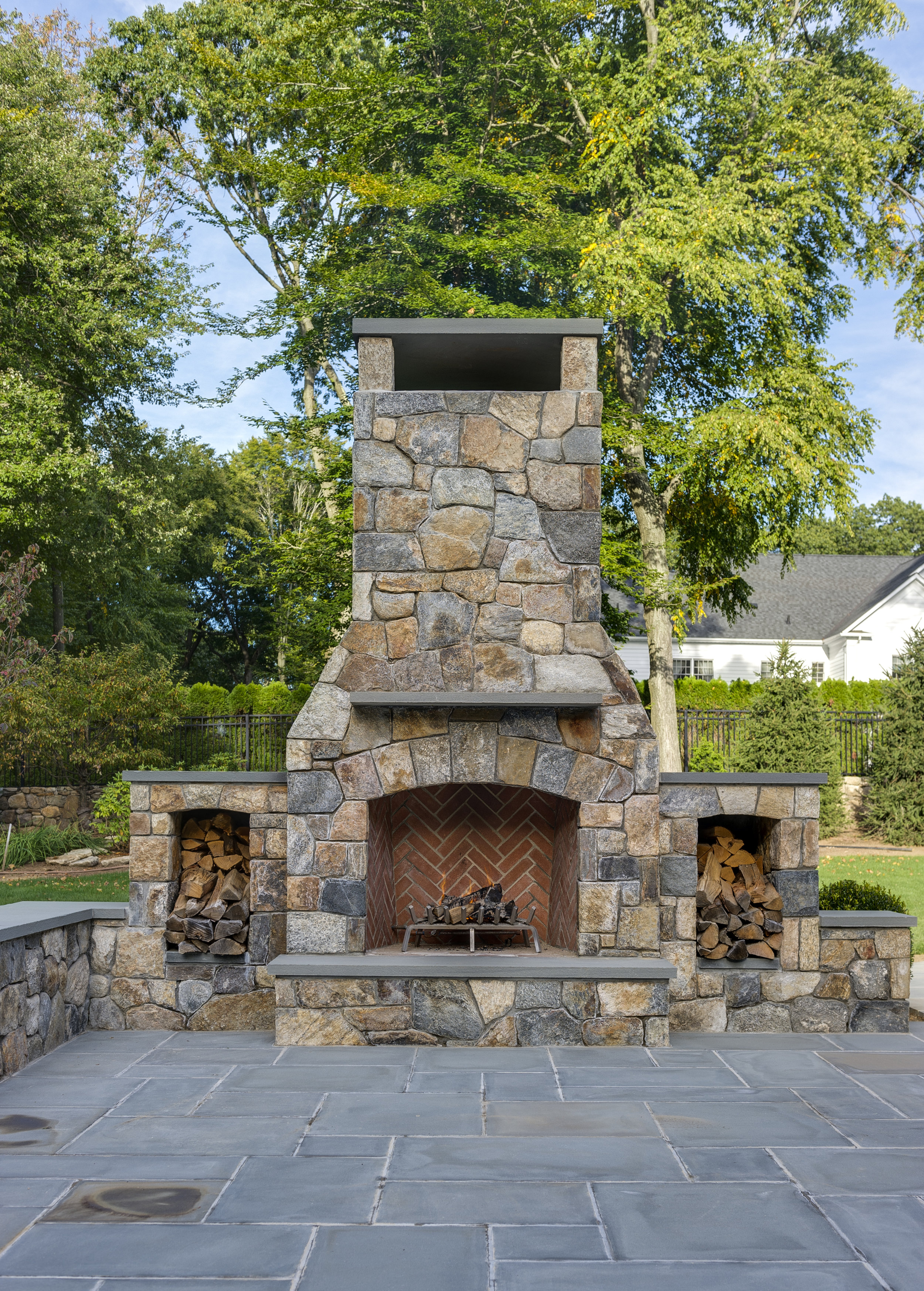 MATERIALS USED: CT FIELDSTONE, MOSAIC CUT FIREPLACE; BLUE, THERMAL BLUESTONE HEARTH