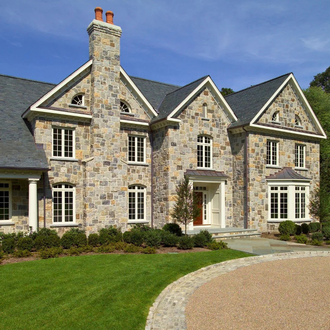 A stunning first impression. This home&rsquo;s front entrance and facade are crafted with Square &amp; Rec Weathered Thinstone Veneer, complemented by a gravel driveway for timeless curb appeal.